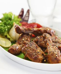 A plate of delicious pot chicken, accompanied by veggies and served with refreshing glass of water