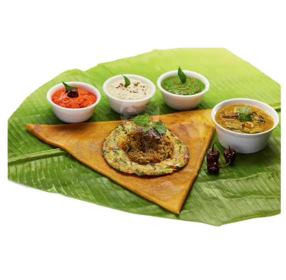 Delicious mixed vegetable omlette on top of dosa served in banana leaf with three chutneys & sambar