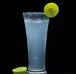 A elegant glass is filled with a refreshing lemon drink topped with a slice of green apple and lime