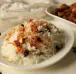 Steamed Basmathi rice sauted with ghee, spices & nuts served in bowl with side dish as per choice.