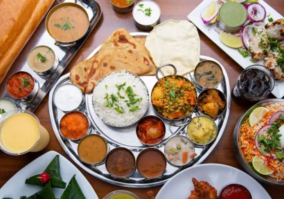 An array of Indian cuisine displayed on a table, featuring a variety of flavorful dishes.